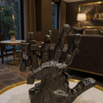 modern abstract hand sculpture, matte black resin, wall mounted design by luxeholic