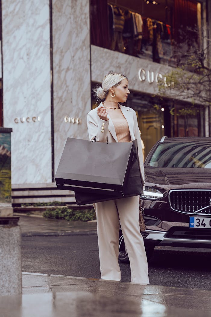 Chic woman with shopping bags at Gucci store in İstanbul's luxury district.